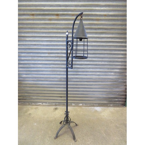 743 - An unusual early 20th century 18th century style hanging cast iron lamp on 4 splayed legs.