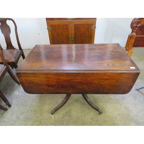 746 - An antique mahogany pedestal drop leaf table with single drawer on 4 splayed legs with brass claw fe... 