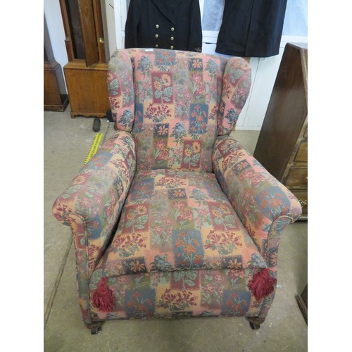 752 - A vintage fireside armchair with wing back and cushioned seat.