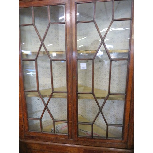 758 - An antique oak corner cupboard with glazed doors and 2 shelves and cupboard under on bracket feet wi... 