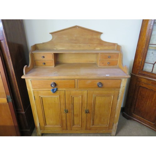 759 - An antique pine dresser with fitted top having four drawers and shaped back with 2 drawers and cupbo... 