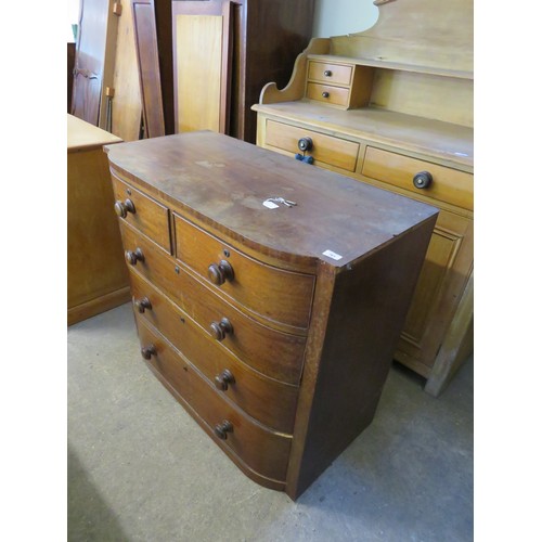 761 - An antique bow fronted mahogany chest of 2 short and 3 long drawers with wooden handles.