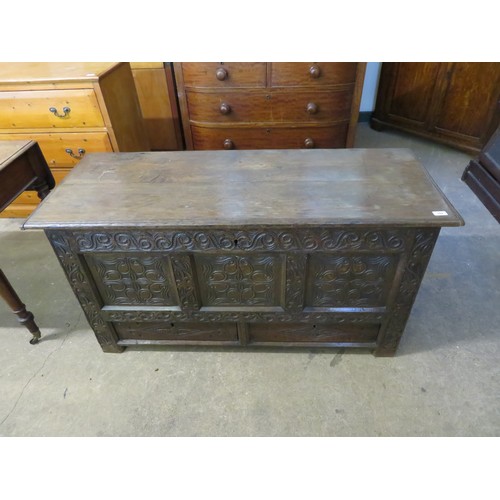 762 - An antique oak coffer with ornate carved decoration to the front and having 2 base drawers, measurin... 