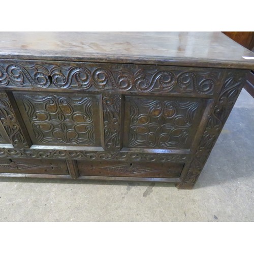 762 - An antique oak coffer with ornate carved decoration to the front and having 2 base drawers, measurin... 