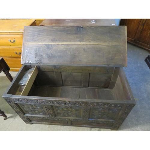 762 - An antique oak coffer with ornate carved decoration to the front and having 2 base drawers, measurin... 