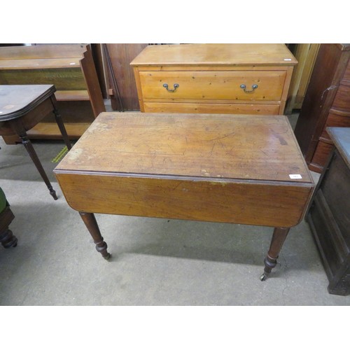 763 - An antique mahogany drop leaf table with 2 drawers on turned legs with brass castors.