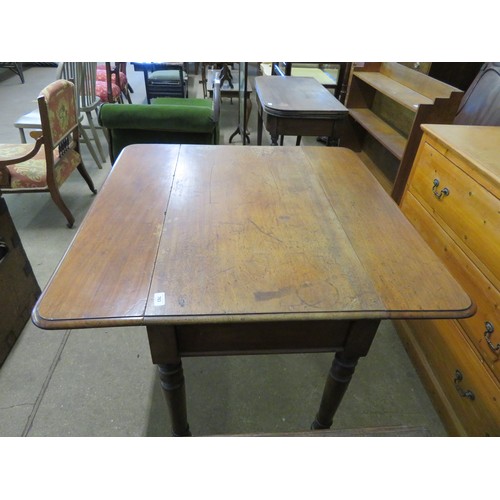 763 - An antique mahogany drop leaf table with 2 drawers on turned legs with brass castors.