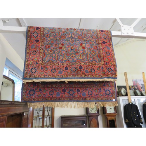 765 - An Eastern rug with pink and blue ground and floral decoration - approximately 204cm x 131cm.