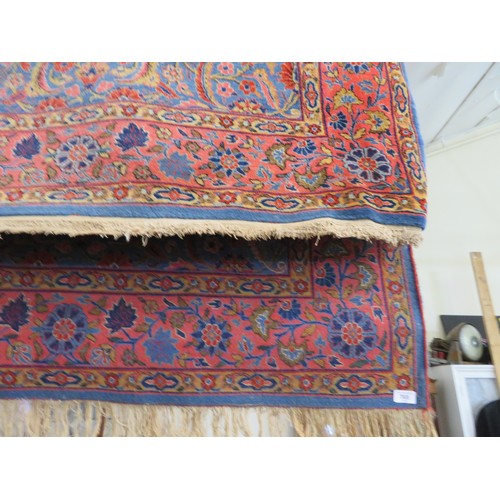 765 - An Eastern rug with pink and blue ground and floral decoration - approximately 204cm x 131cm.