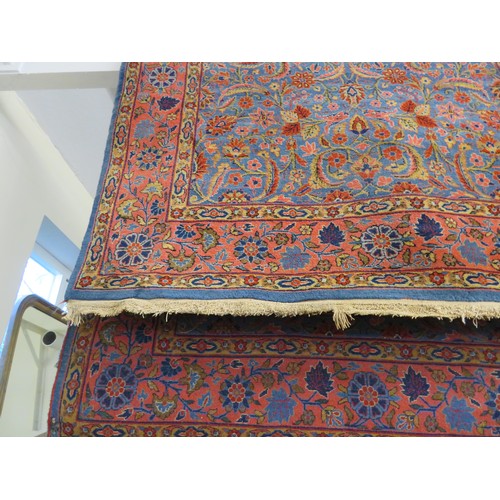 765 - An Eastern rug with pink and blue ground and floral decoration - approximately 204cm x 131cm.