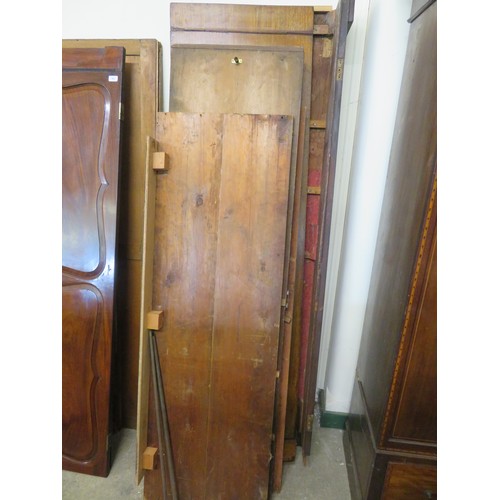 767 - An antique mahogany double wardrobe with shaped decorative panels and inlaid decoration.