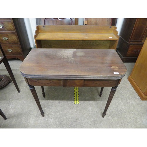 769 - An antique mahogany fold over tea table on reeded legs.