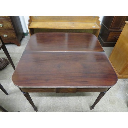 769 - An antique mahogany fold over tea table on reeded legs.