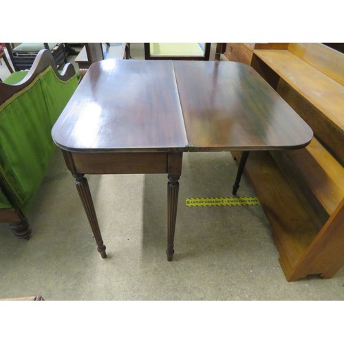 769 - An antique mahogany fold over tea table on reeded legs.