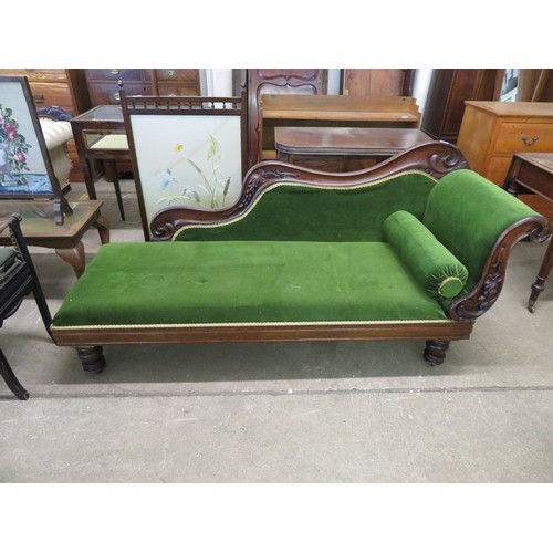 770 - An antique mahogany chaise longue with carved grape decoration on turned legs having green upholster... 