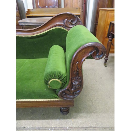 770 - An antique mahogany chaise longue with carved grape decoration on turned legs having green upholster... 