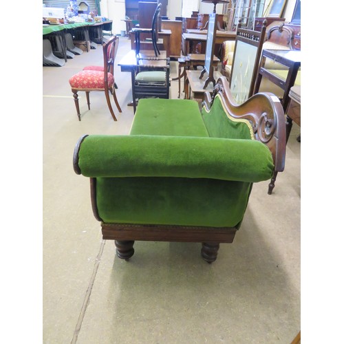 770 - An antique mahogany chaise longue with carved grape decoration on turned legs having green upholster... 