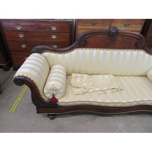 778 - An antique mahogany sofa with carved decoration and scroll arms upholstered in gold striped material... 