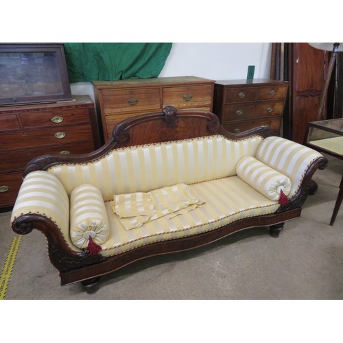 778 - An antique mahogany sofa with carved decoration and scroll arms upholstered in gold striped material... 