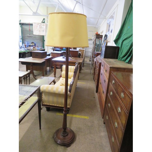 781 - A mahogany standard lamp with reeded column and circular base on 3 feet.