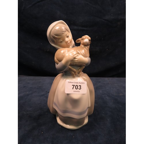 703 - A Nao figurine of a girl holding a lamb in her arms.