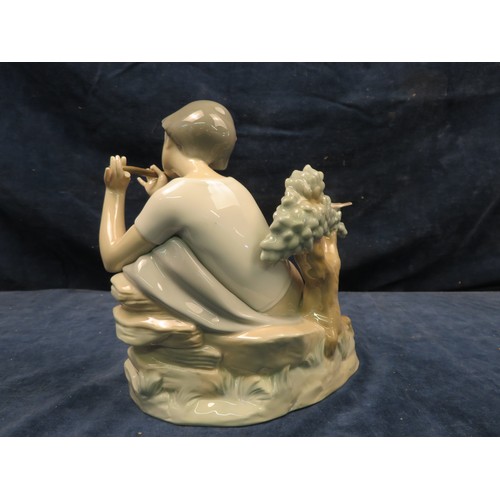 708 - A Lladro figurine of a boy holding a flute.