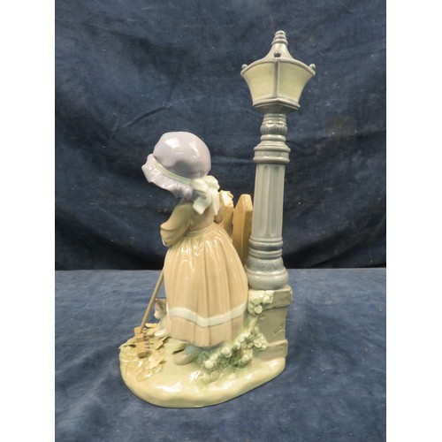 711 - A Lladro figurine of a girl under gas lamp with sweeping brush.