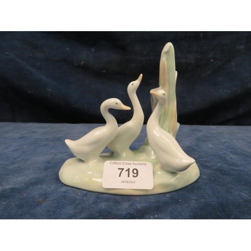 719 - A Nao figurine of a plinth with three geese standing.