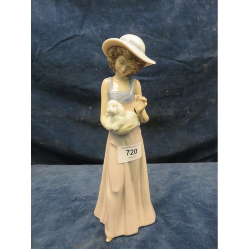 720 - A Nao figurine of lady holding a puppy in her arms.