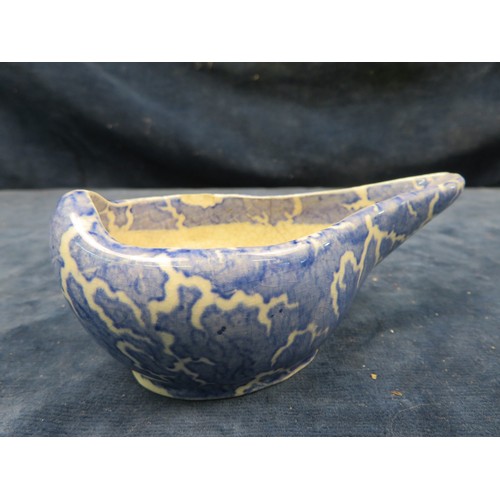 726 - An early 19th century Staffordshire Pottery pap boat with blue mottled hand-painted decoration.