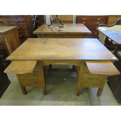 794 - An oak desk with slides and 5 drawers.