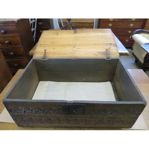 795 - An unusual antique trunk with carved front panel and 2 iron carrying handles, 70.5cm x 44.5cm x 28cm... 