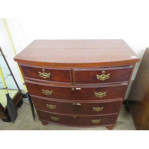 800 - An antique mahogany bow fronted chest of 2 short and 3 long drawers on turned bun feet with brass dr... 