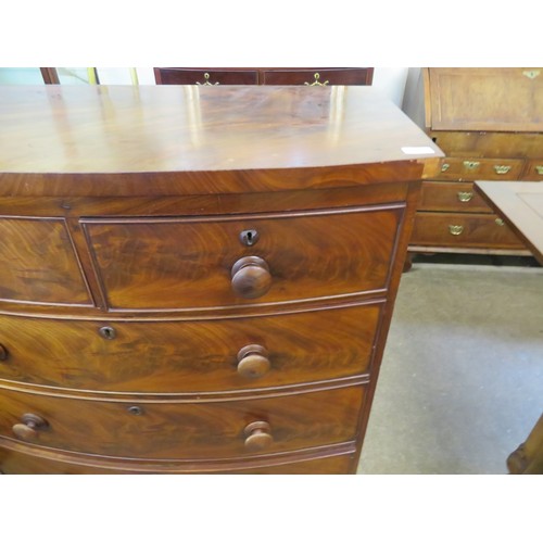 801 - An antique mahogany bow fronted chest of 2 short and 3 long drawers with turned wooden handles on br... 