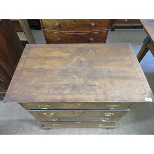 802 - An antique mahogany and inlaid chest of 4 long drawers with brass drop handles on shaped bracket fee... 