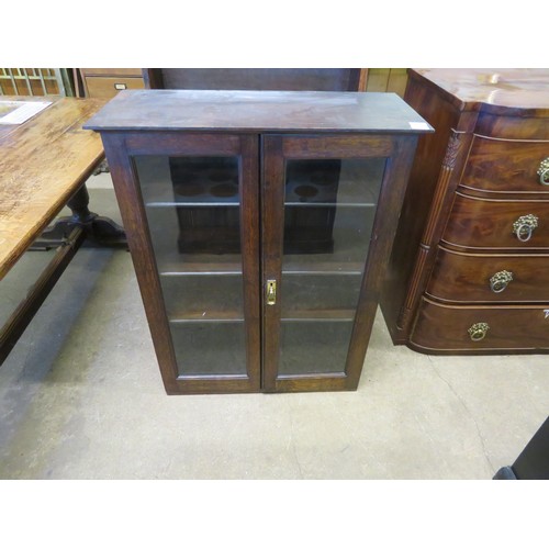 811 - A vintage oak cupboard with glazed doors and 3 adjustable shelves.