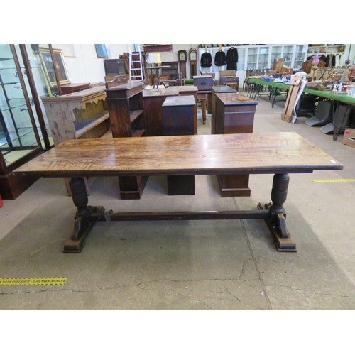 813 - An oak boarded table on baluster and stretcher legs - 213cm long x 81.5cm wide.