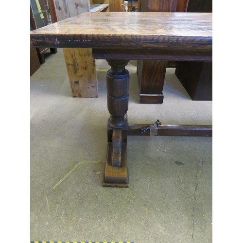 813 - An oak boarded table on baluster and stretcher legs - 213cm long x 81.5cm wide.