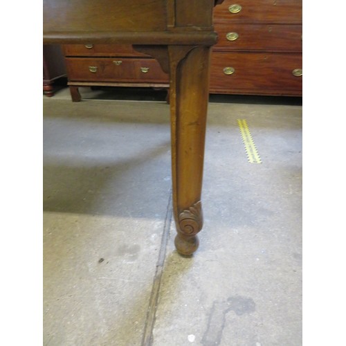 796 - An oak draw leaf dining room table on square and carved legs.