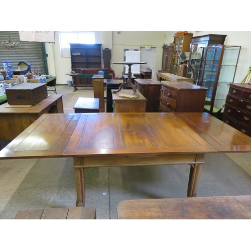 796 - An oak draw leaf dining room table on square and carved legs.