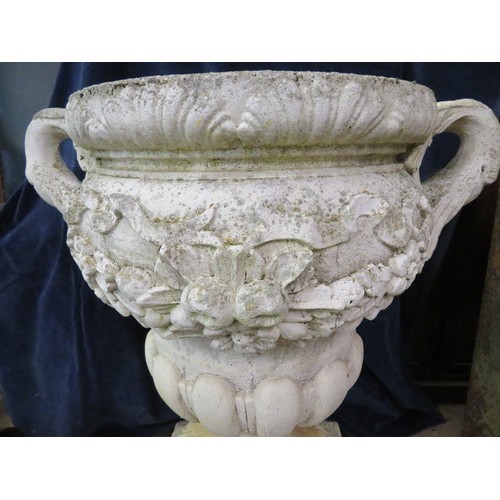 3 - A large weathered vintage garden urn with 2 handles and relief fawn decoration on pedestal base appr... 