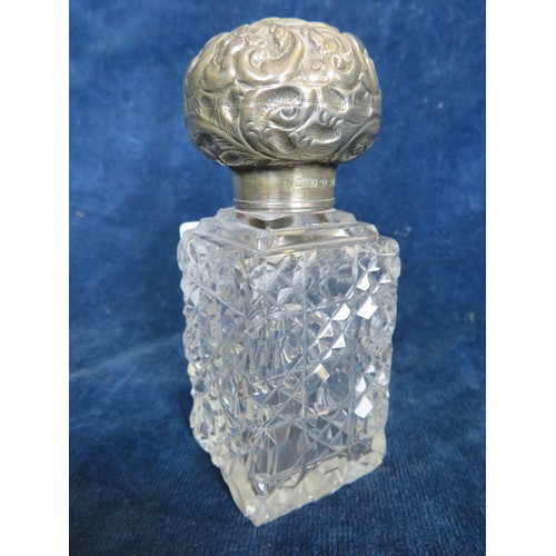 42 - A cut glass scent bottle with silver top, marked Birmingham.