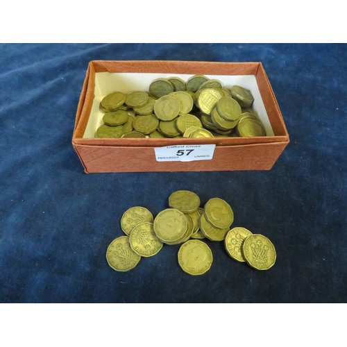 57 - A quantity of brass 20th century threepenny pieces.