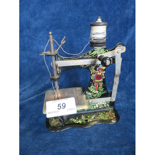 59 - A miniature manual sewing machine being Muller's Kinder-Nahmaschime number 162505 with painted decor... 