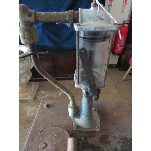 1 - A vintage oil tank with crank handle pump.