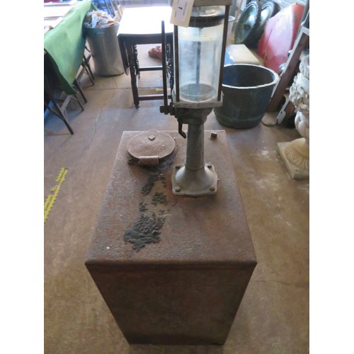1 - A vintage oil tank with crank handle pump.