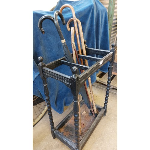 11 - An umbrella stand having barley twist corners and cast inset tray.