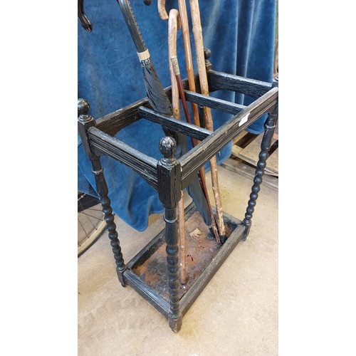 11 - An umbrella stand having barley twist corners and cast inset tray.