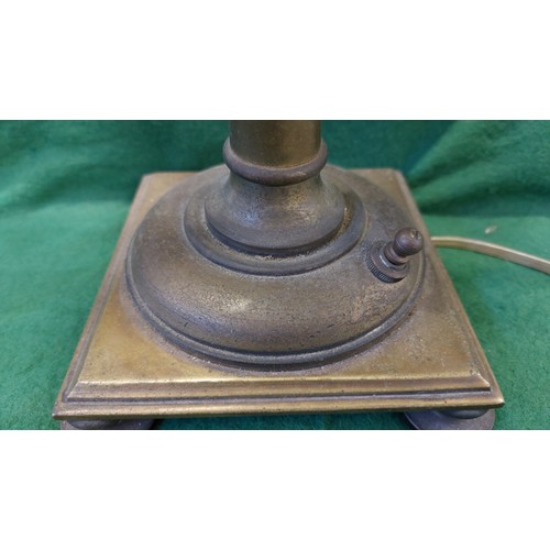 497 - A brass double oil lamp on 4 bun style feet, with 2 glass shades.