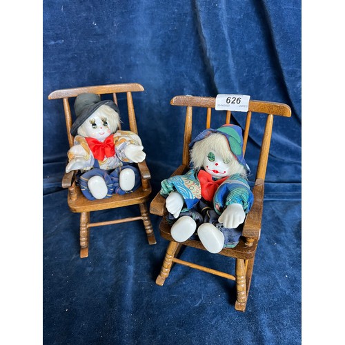 626 - Two Pierrot style Clown Doll's having porcelain face, hands and feet in miniature rocking chairs.